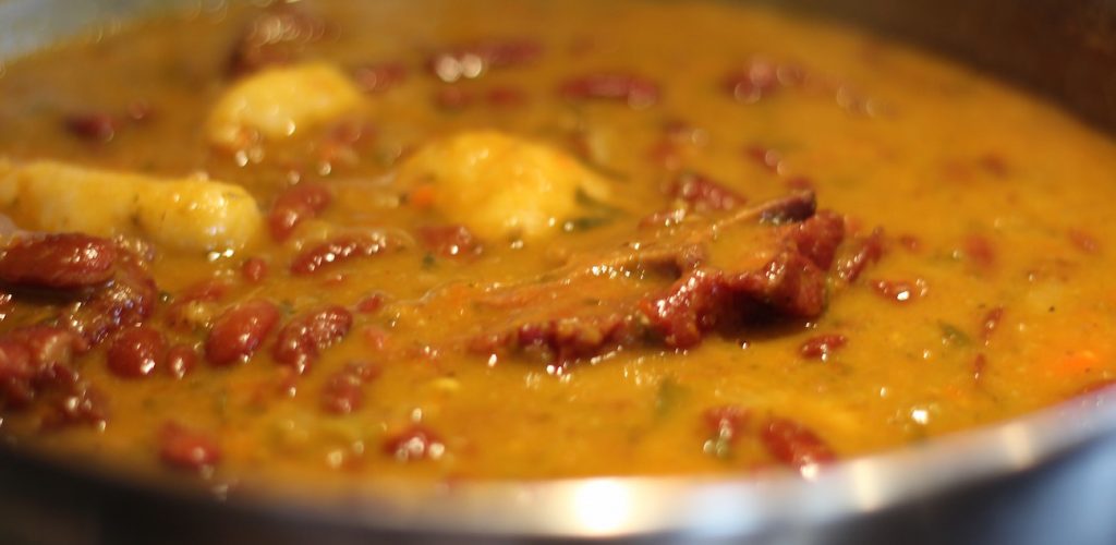 a rich coconutty broth thick with delicate pigeon peas, skins bursting--and really sticky dumplings